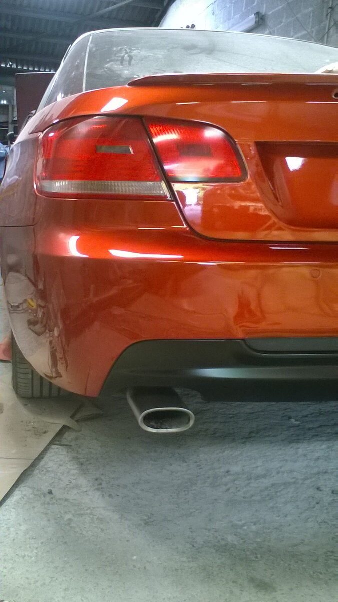 BMW rear bumper and quarter in orange metallic